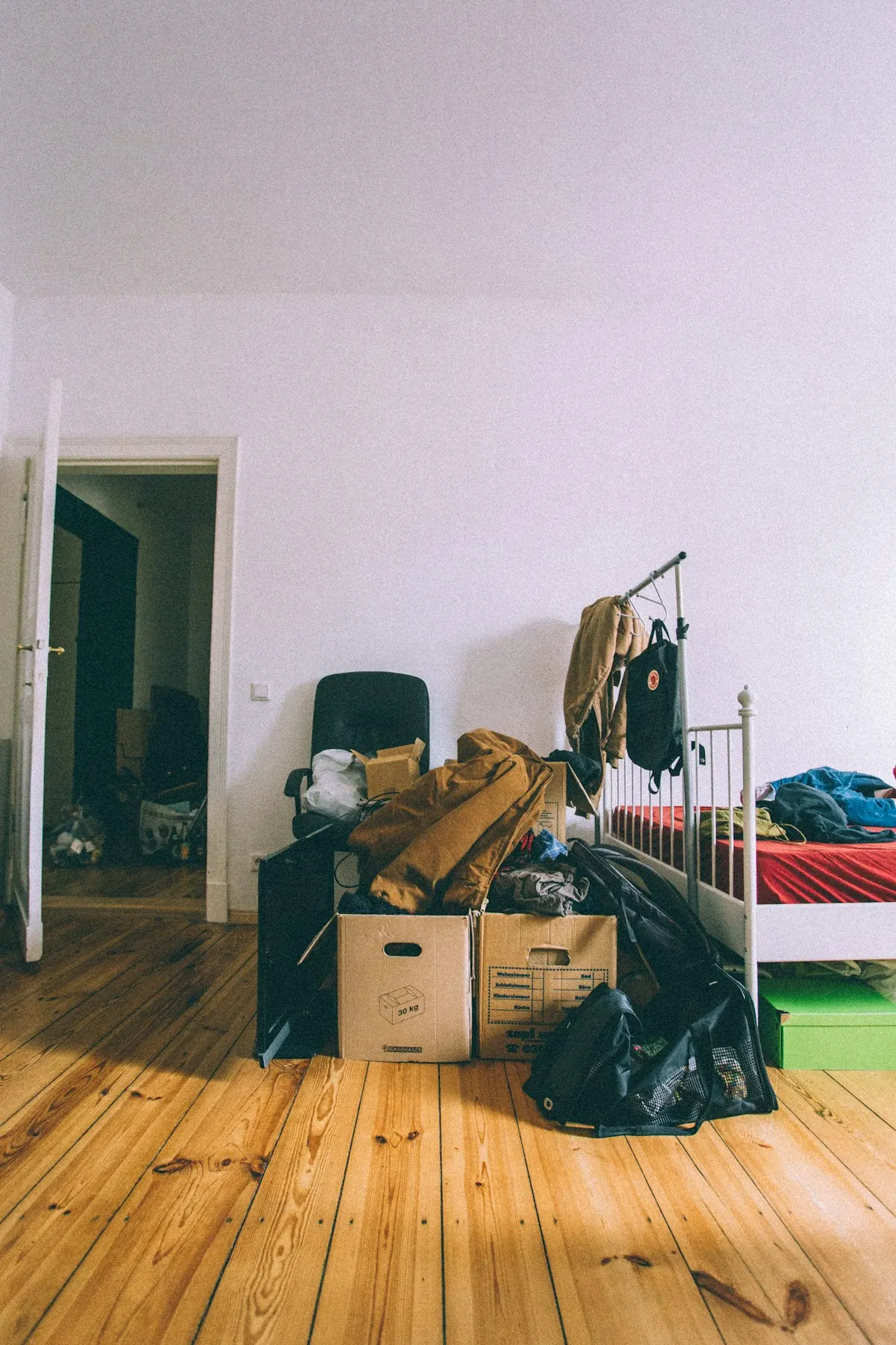 Room part-way through a house clearance, boxes packed on the floor